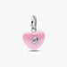 Pink heart-shaped charm with silver accents on a white background