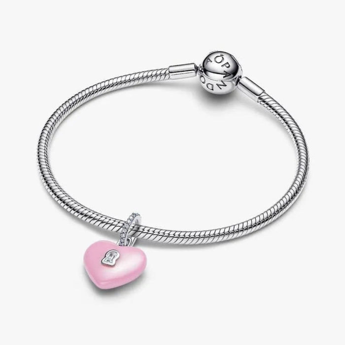 Silver bracelet with a pink heart-shaped charm on a white background