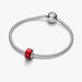 Silver bracelet with a red charm on a white background