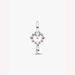 Silver heart charm with red stones on a light background