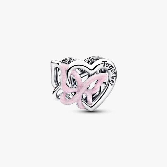 Silver heart and butterfly shaped charm on a light background