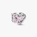 Silver heart and butterfly shaped charm on a light background