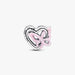 Silver heart and butterfly shaped charm on a light background
