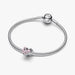 Silver heart and butterfly shaped charm on a light background