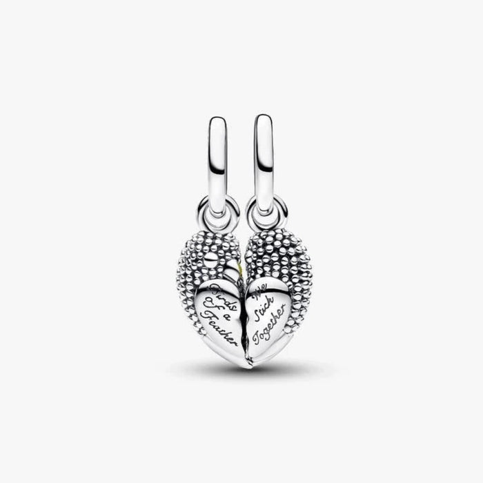 Silver bird-shaped charm on a light background