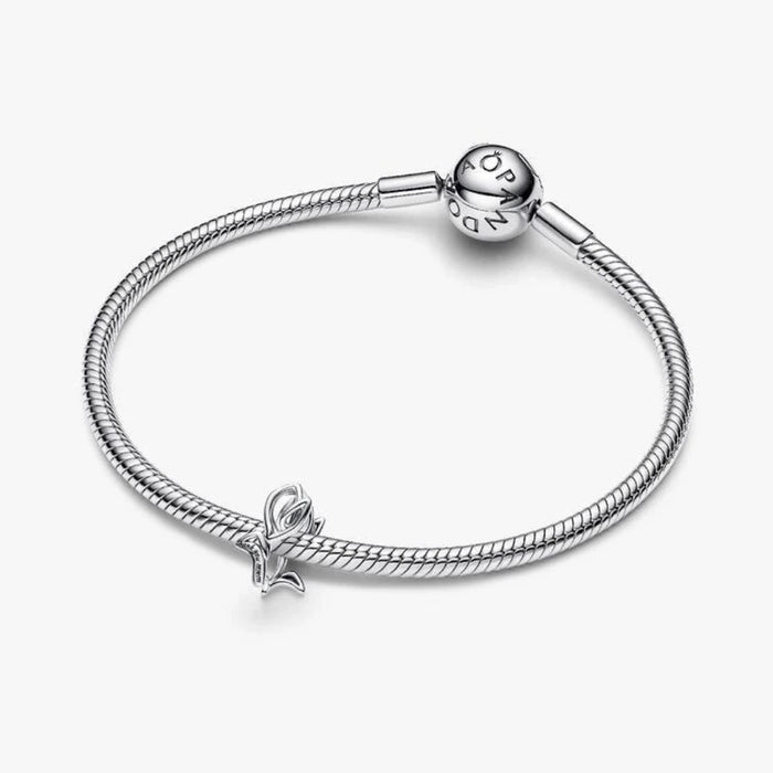 Silver bracelet with a tulip shaped charm on a light background