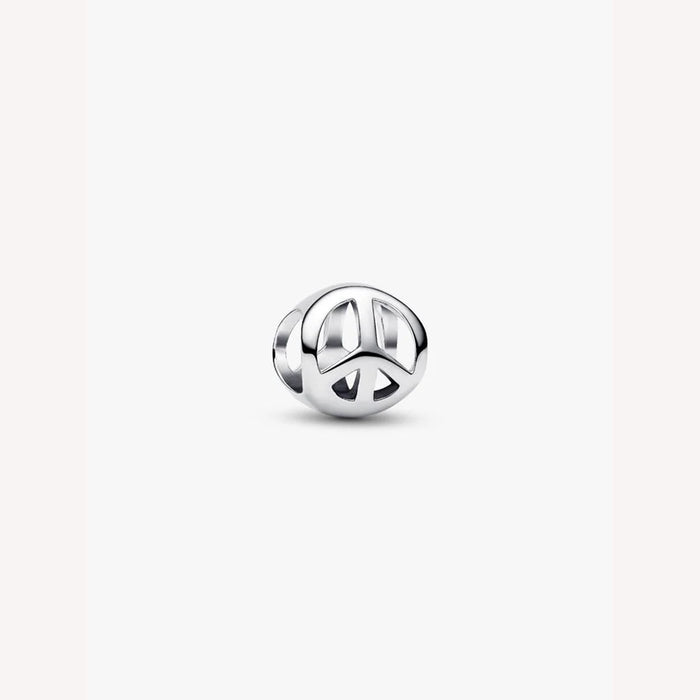 Silver peace symbol charm on a light background