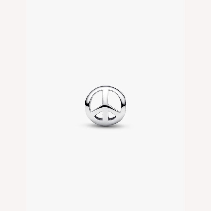 Silver peace symbol charm on a light background