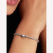 Silver bracelet with a butterfly charm on a wrist