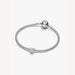 Silver bracelet with a heart-shaped charm on a white background