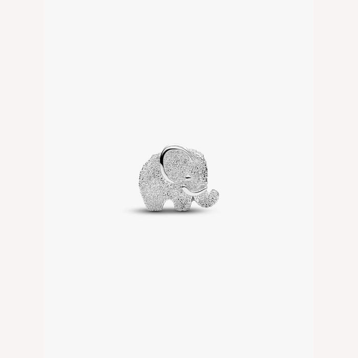 Silver elephant charm with embedded stones on a light pink background