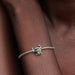 A woman wearing a bracelet featuring a turtle charm on her wrist.