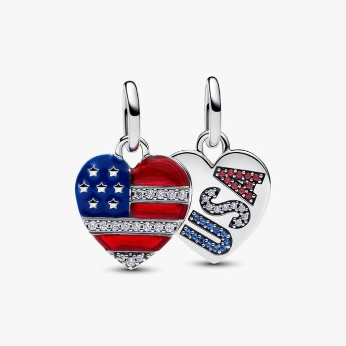 Sterling silver-tone dangle charm set featuring an American flag heart and a white heart with sparkling USA lettering in red, white, and blue crystals, designed for charm bracelets
