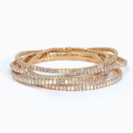 White beaded stretch bracelet featuring six strands of clear and milky white crystal beads arranged in a layered design for an elegant everyday look.