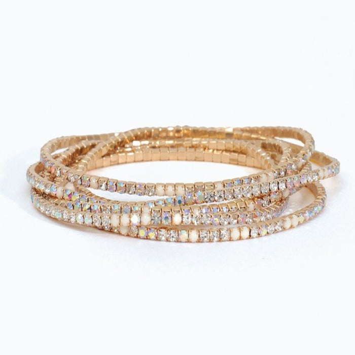 White beaded stretch bracelet featuring six strands of clear and milky white crystal beads arranged in a layered design for an elegant everyday look.