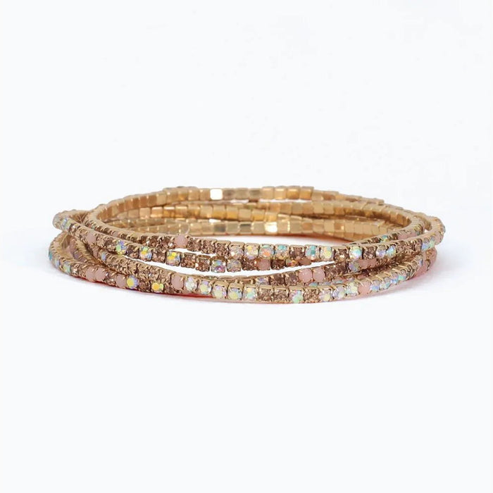 Periwinkle bracelet with six strands of blush, champagne, and AB crystals in a sparkling layered design.