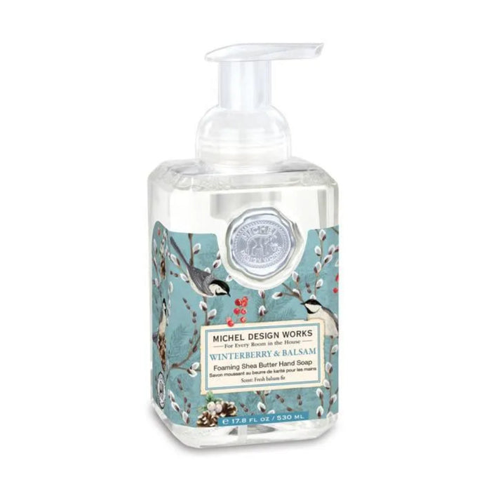Michel Design Works Winterberry & Balsam foaming hand soap in a clear pump bottle with birds, red berries, and winter branches on a blue-green label.
