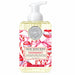 Michel Design Works Peppermint foaming hand soap in a clear bottle with a white pump, candy cane artwork, and pink ribbons.
