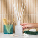 This elegant reed diffuser continuously releases the signature Inis fragrance, creating a clean, uplifting atmosphere without the need for flames or electricity.