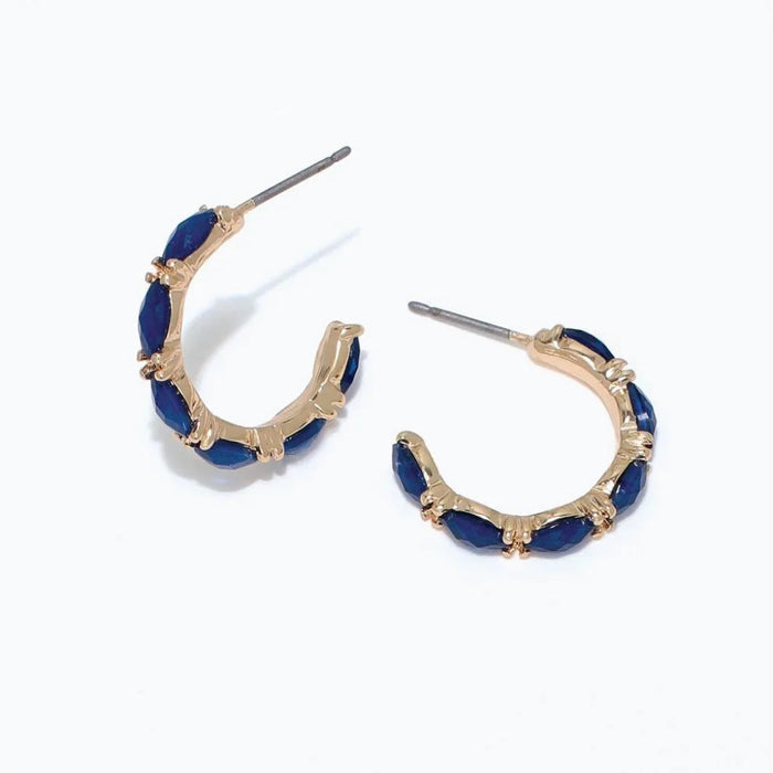 Periwinkle gold hoop earrings with faceted navy accents and a polished, elegant design.