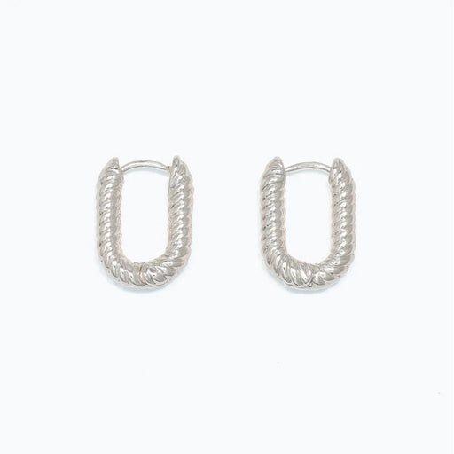 Periwinkle chic ribbed silver huggie earrings featuring a textured finish and compact hoop design