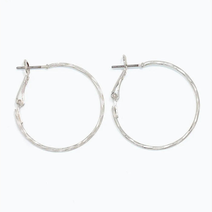 Periwinkle delicately textured silver hoop earrings with a classic silhouette and refined finish