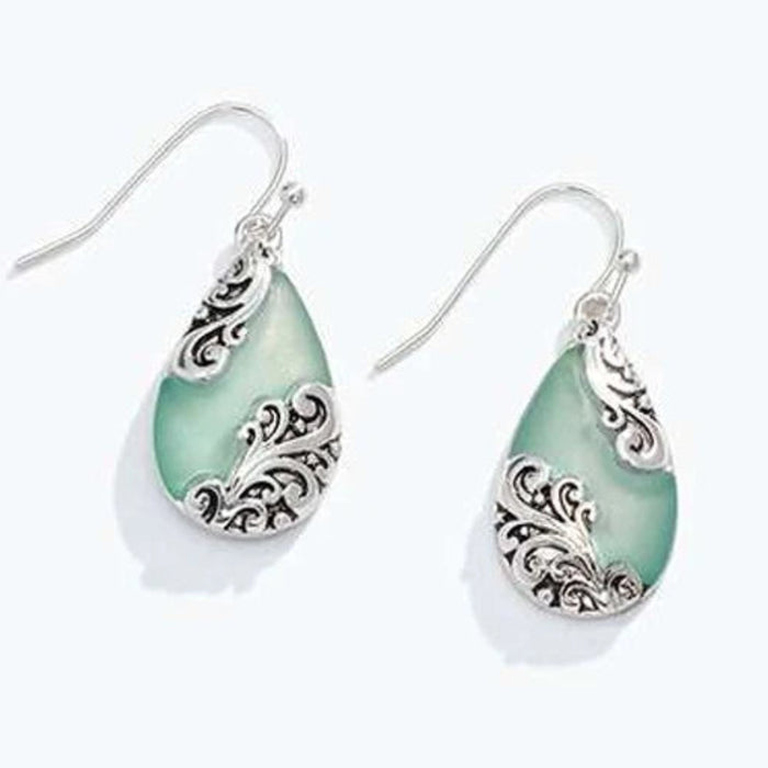 This Aqua Drop With Silver Filigree Earring by Periwinkle showcases a captivating aqua-colored drop framed by intricate silver filigree detailing for a timeless vintage-inspired look. 