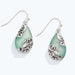This Aqua Drop With Silver Filigree Earring by Periwinkle showcases a captivating aqua-colored drop framed by intricate silver filigree detailing for a timeless vintage-inspired look. 