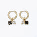 Periwinkle black clover and pearl huggie earrings featuring elegant clover accents and delicate pearl details