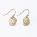 Hammered and polished gold layered earrings with a textured finish