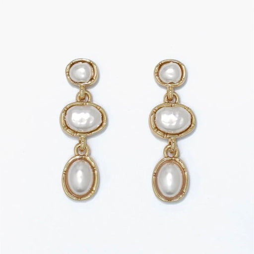 Pearl drop earrings featuring organic gold shapes and elegant warm metallic accents