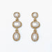 Pearl drop earrings featuring organic gold shapes and elegant warm metallic accents