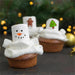 Snowman-themed cupcakes with marshmallow snowman on a festive background