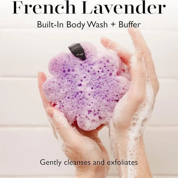 Purple bath bomb with foam, held by hands, against a neutral background with text about its uses.