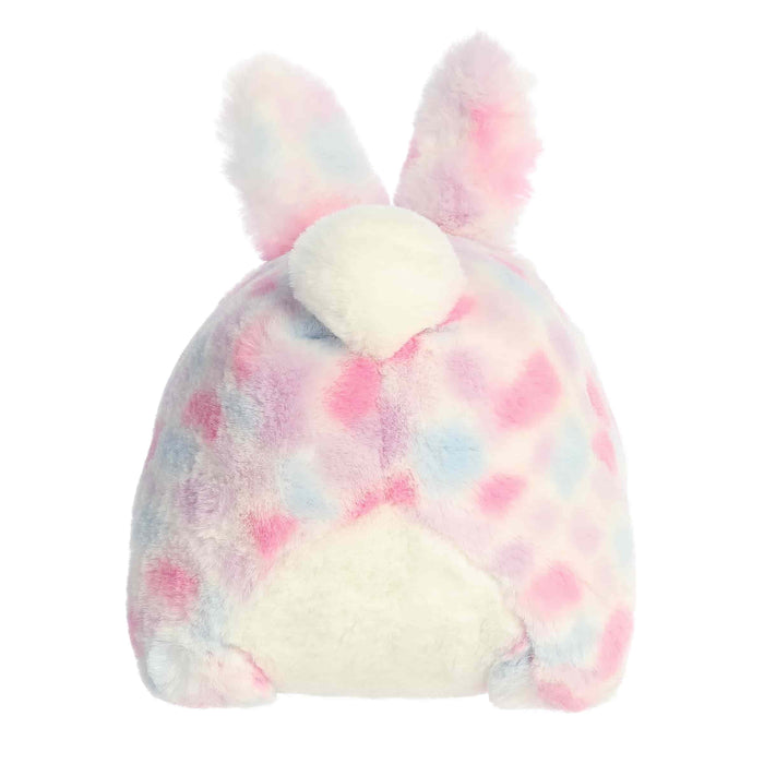 A plush bunny with playful pink and blue spots, complete with a friendly smile and floppy ears.