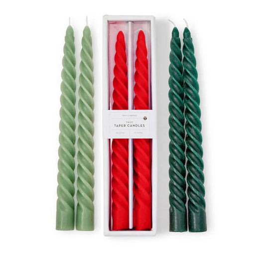 Set of green and red twisted candles with a white box in the center.