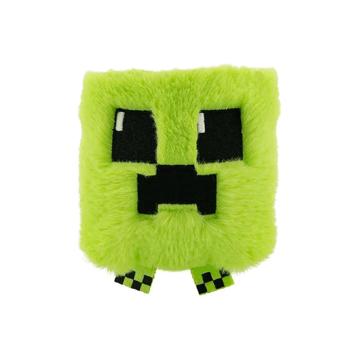 A green Minecraft creeper plushie with a pixelated face, sitting upright on a white background.