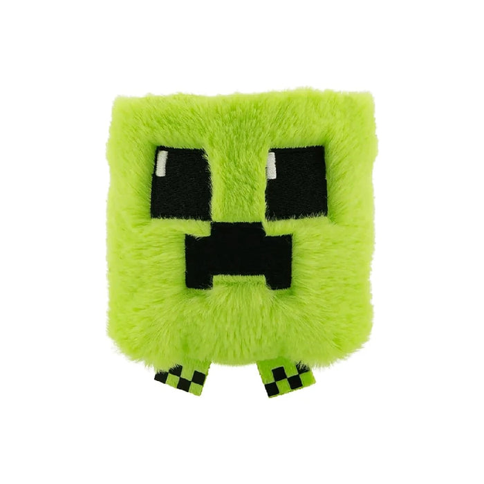 A green Minecraft creeper plushie with a pixelated face, sitting upright on a white background.