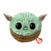 A plush toy of Child Yoda, featuring large ears and a green face, is displayed against a neutral background.