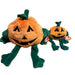 Two plush pumpkins with green leaves on a gray background
