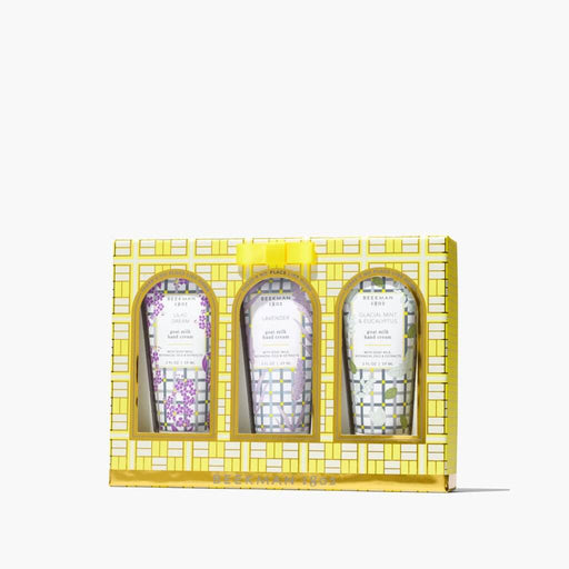 Three skincare products in a decorative yellow box on a white background