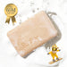 b-coo milk bar soap displayed on a wooden surface, showcasing its smooth texture and simple, elegant design.