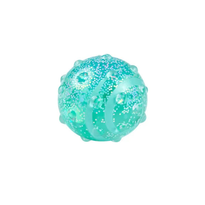 Hape Glow Squish ball in translucent green with raised bumps and curved textured ridges.

