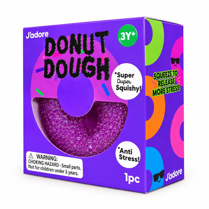 Purple donut-shaped squishy toy with visible bead filling in a purple J’adore Donut Dough box, labeled ages 3 and up.