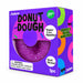 Purple donut-shaped squishy toy with visible bead filling in a purple J’adore Donut Dough box, labeled ages 3 and up.