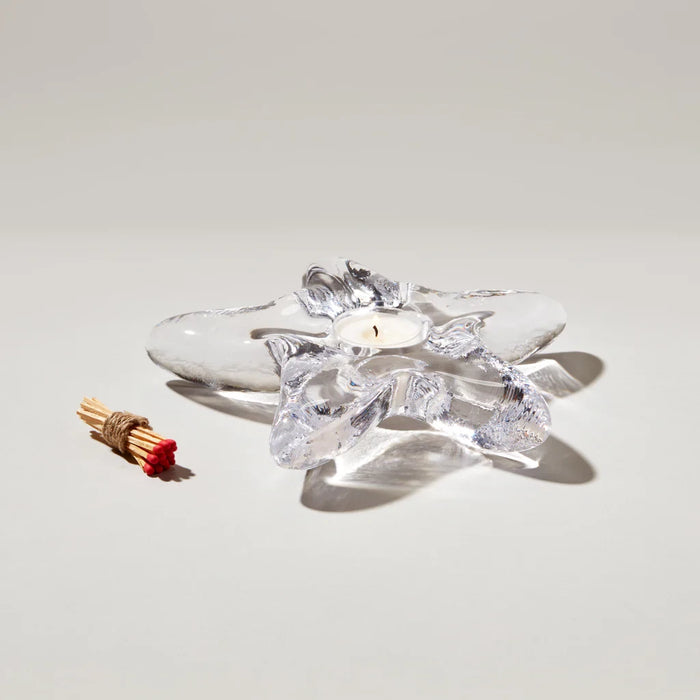 A decorative candle resting on a blue table, enhancing the ambiance of the space.