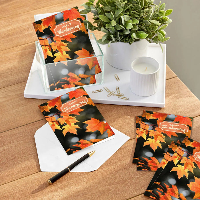 Hallmark Orange Autumn Leaves Thanksgiving card featuring vibrant orange fall leaves on a dark background with foil accents.