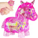 Pink unicorn toy with glittery texture and small pink unicorn figurine held by a hand.
