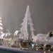 Simon Pearce Vermont Snowy Branches glass evergreen with frosted white branches, displayed beside glass pumpkins and lights