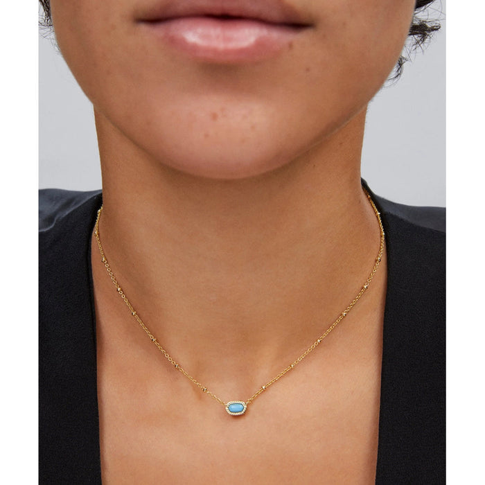 vibrant magnesite stone framed in polished gold-tone metal.